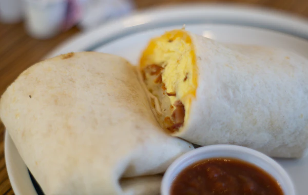 Breakfast burrito filled with scrambled egg