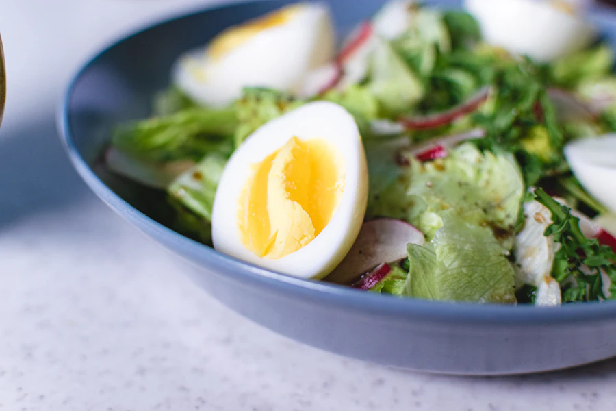 Salad topped with sliced eggs