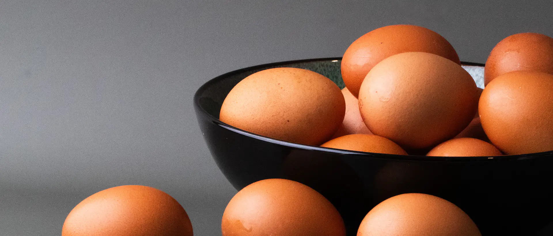 Bowl of brown eggs on a dark table