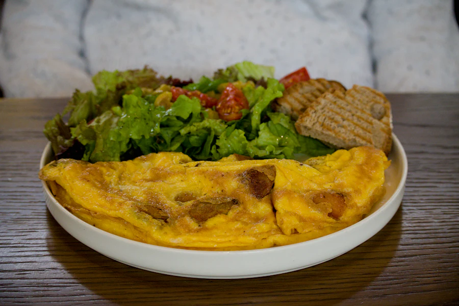 Folded omelet served with salad