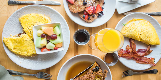 Breakfast spread with omelets and fruit