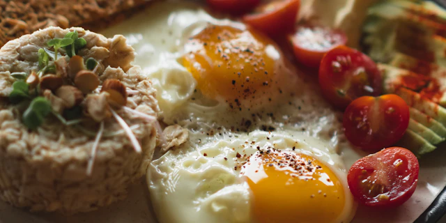 Breakfast plate with fried eggs and tomatoes