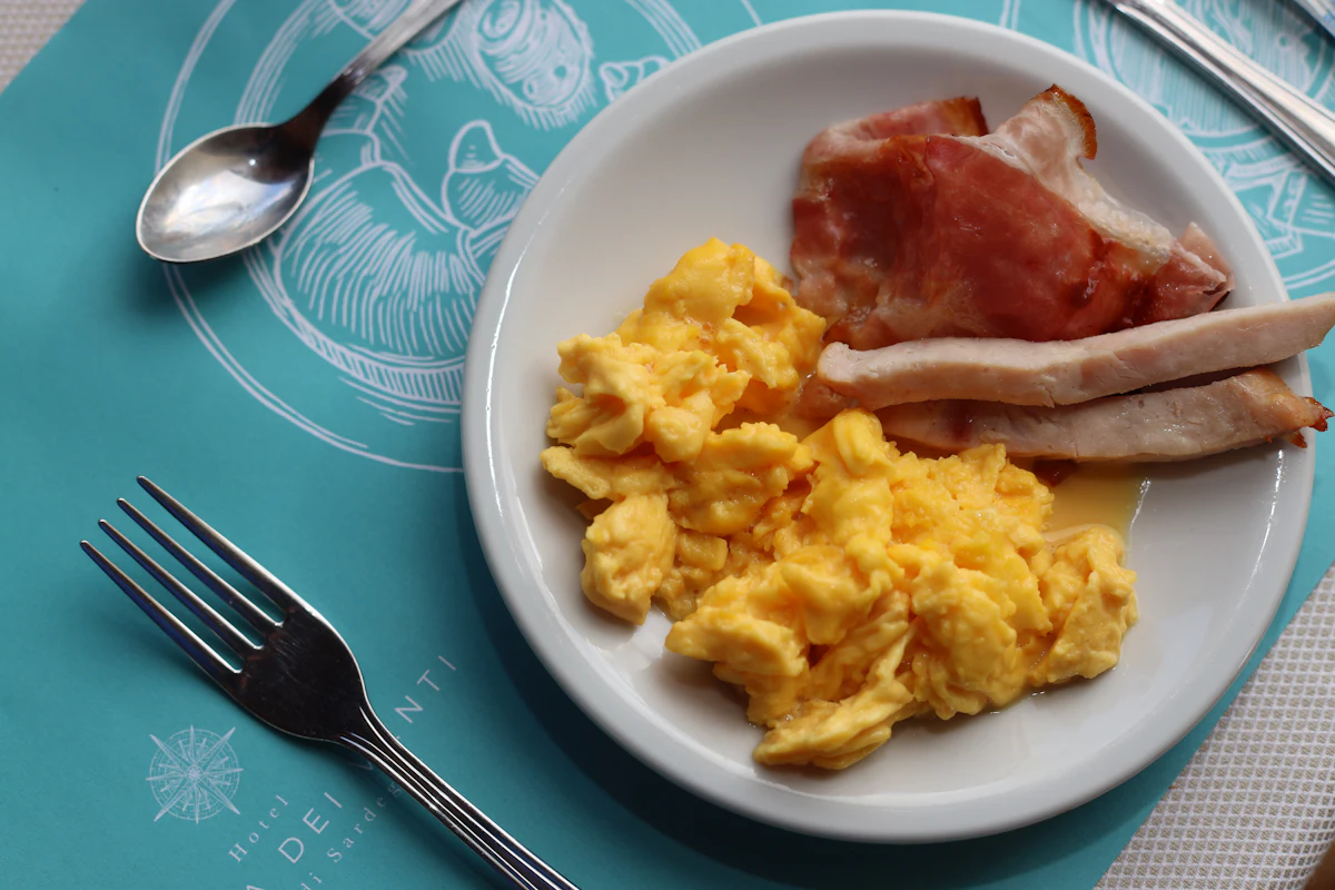 Plate of scrambled eggs with bacon